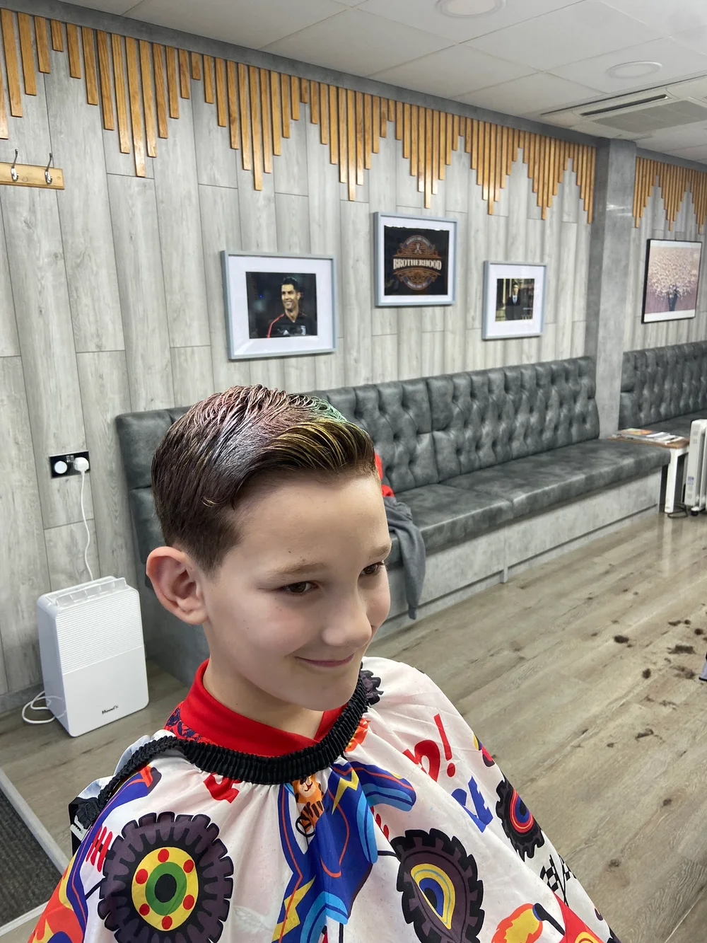 A child's fresh haircut inside Brotherhood barber